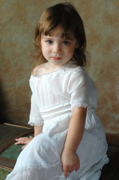 Studio Portrait of Young Girl in White Dress