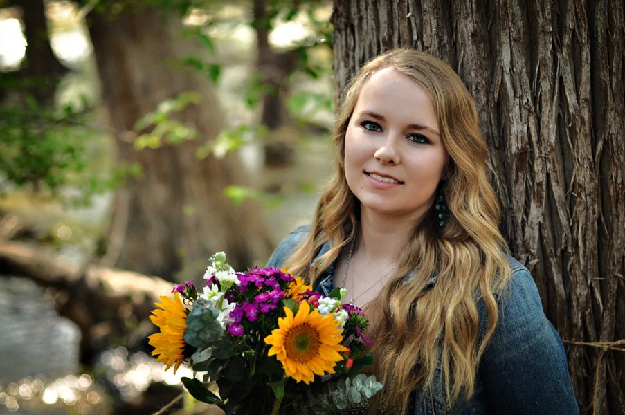 Outdoor senior portrait of girl with flowers
